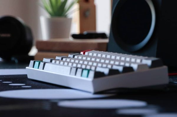 Anne pro mechanical keyboard sitting on a desk mat.