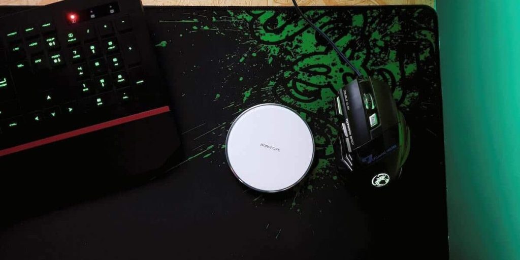 Mouse and keyboard sitting on a mouse pad.