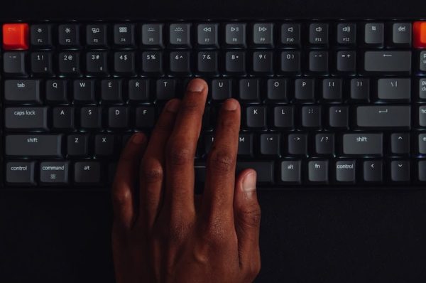 Person typing on a mechanical keyboard.