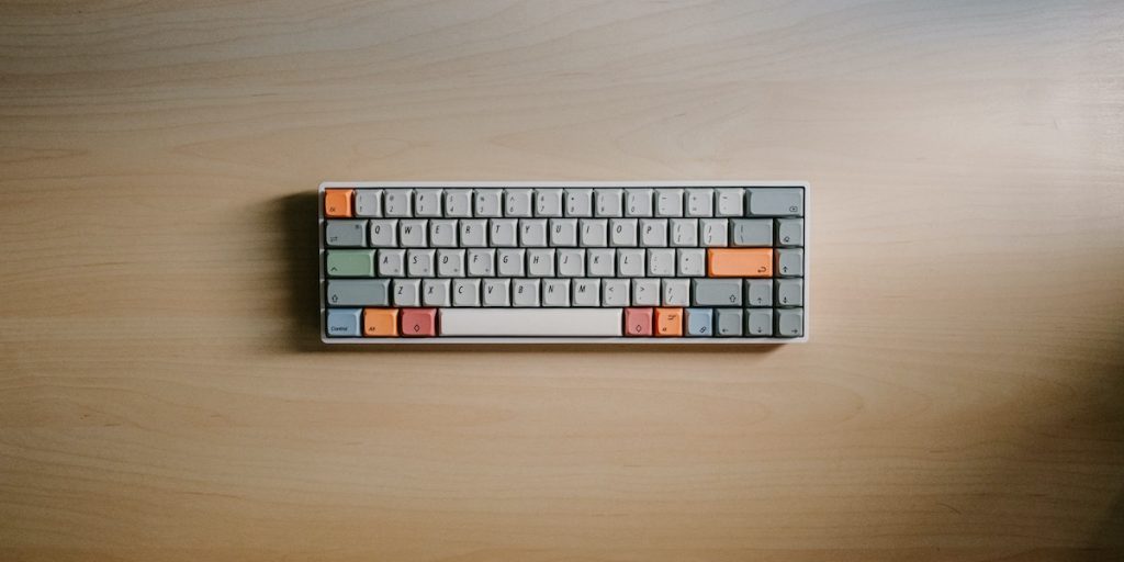 65% mechanical keyboard sitting on a desk.